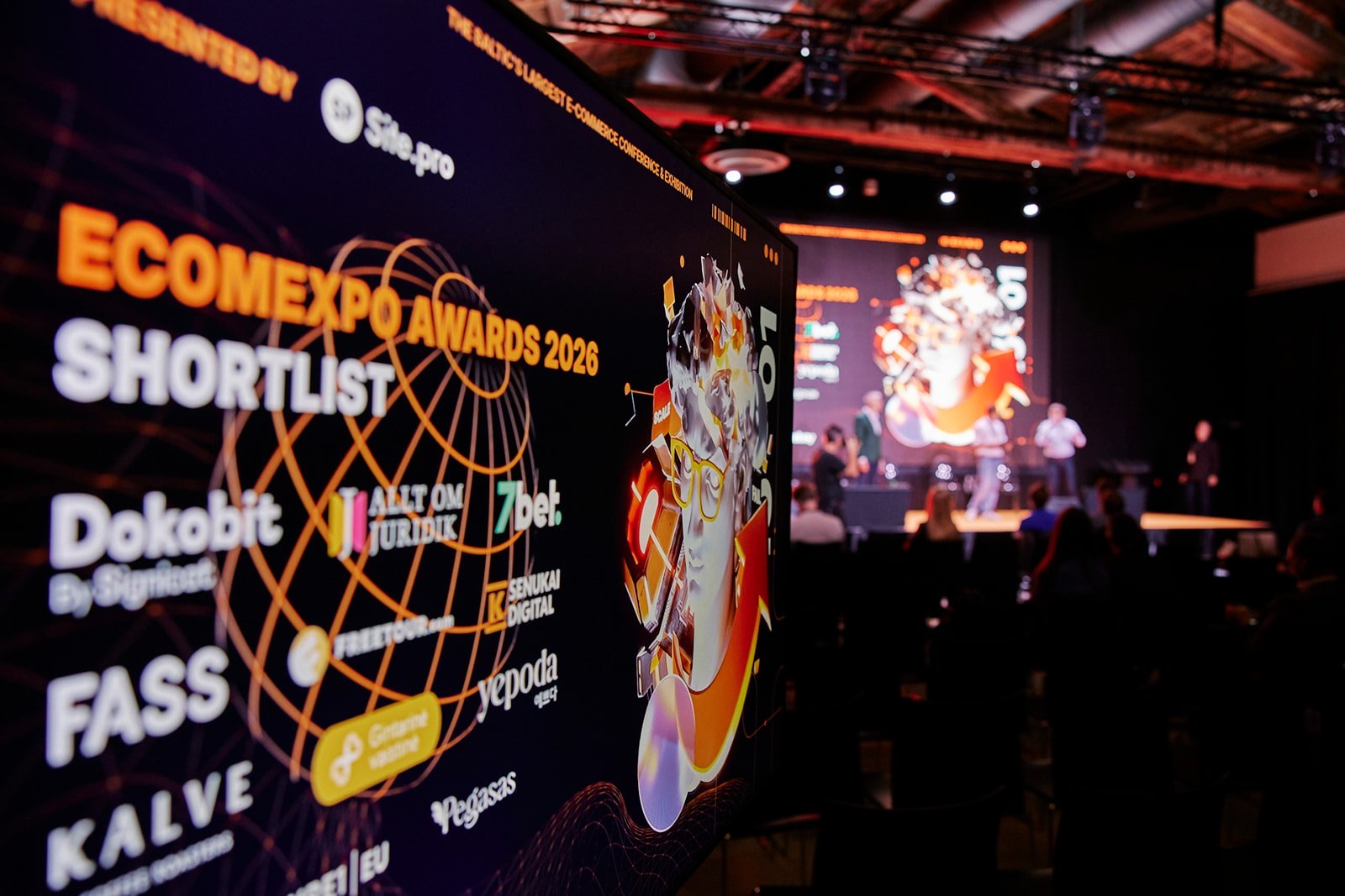 The EcomExpo Awards 2026 shortlist on a large screen, with the stage in the background